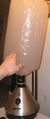 A forced-air vaporizer. The detachable balloon (top) fills with vapors that are then inhaled.